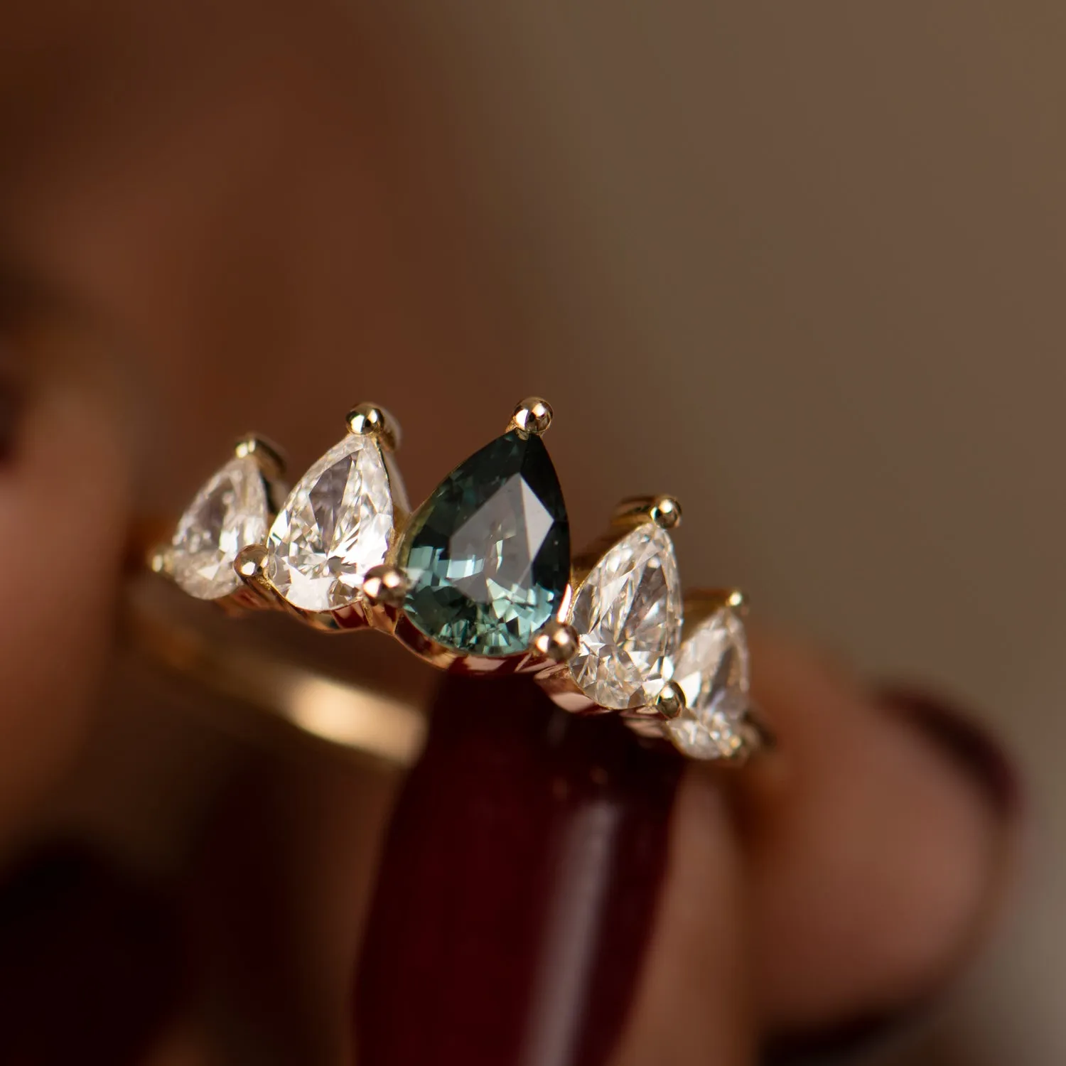 Unique Engagement ring with a Pear Cut Teal Sapphire and Diamonds