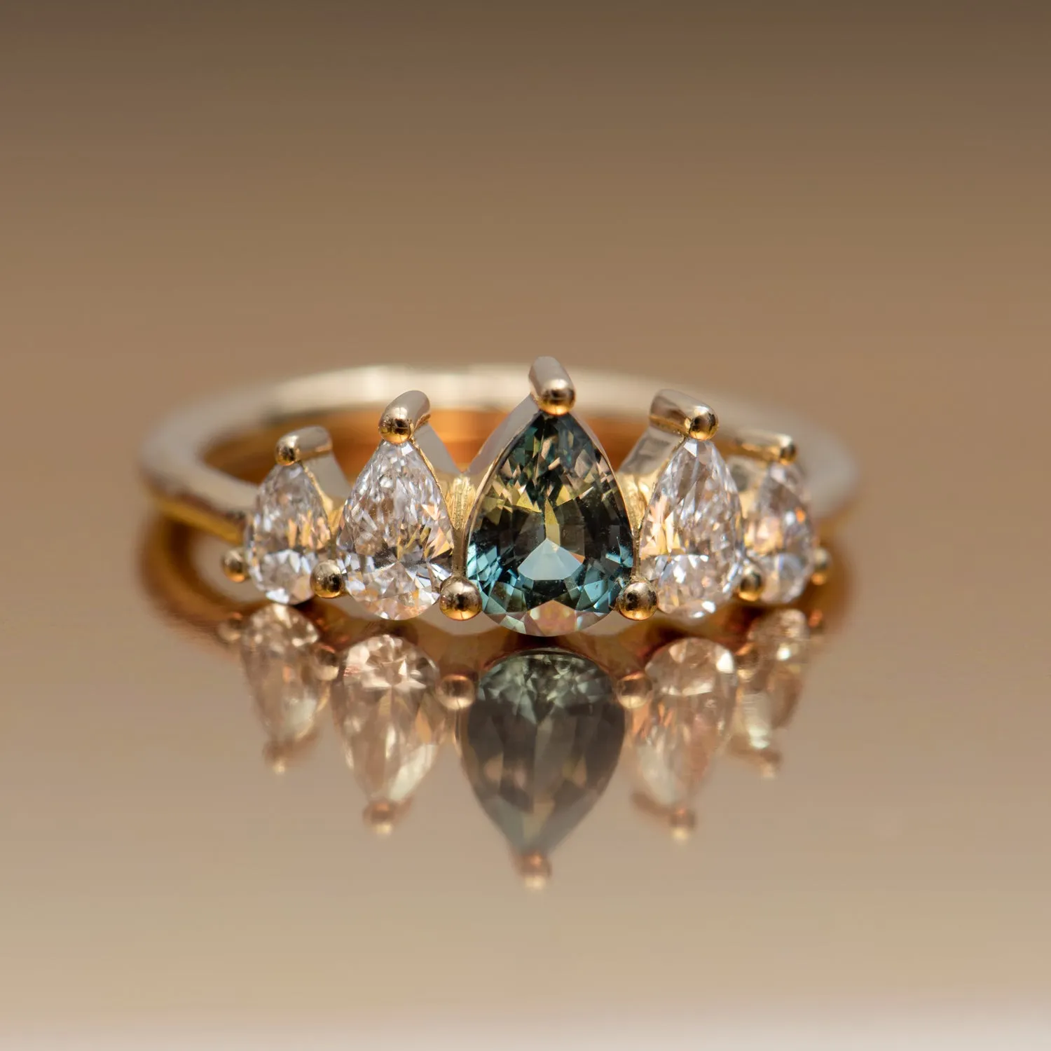 Unique Engagement ring with a Pear Cut Teal Sapphire and Diamonds